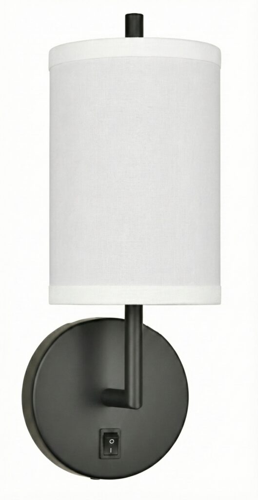 Matte black single cylinder headboard sconce for modern bedroom decor.