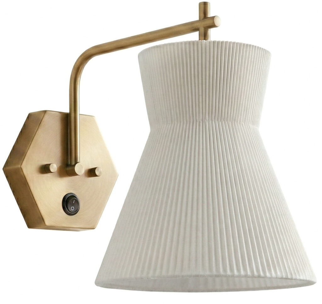 Antique brass wall sconce with pleated fabric shade for elegant lighting.
