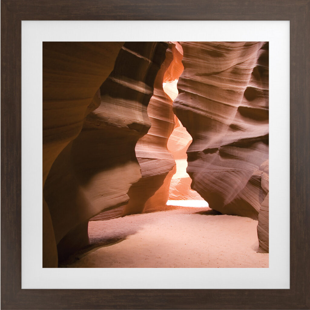 Desert canyon landscape artwork in a square frame, highlighting natural rock formations and warm sun.