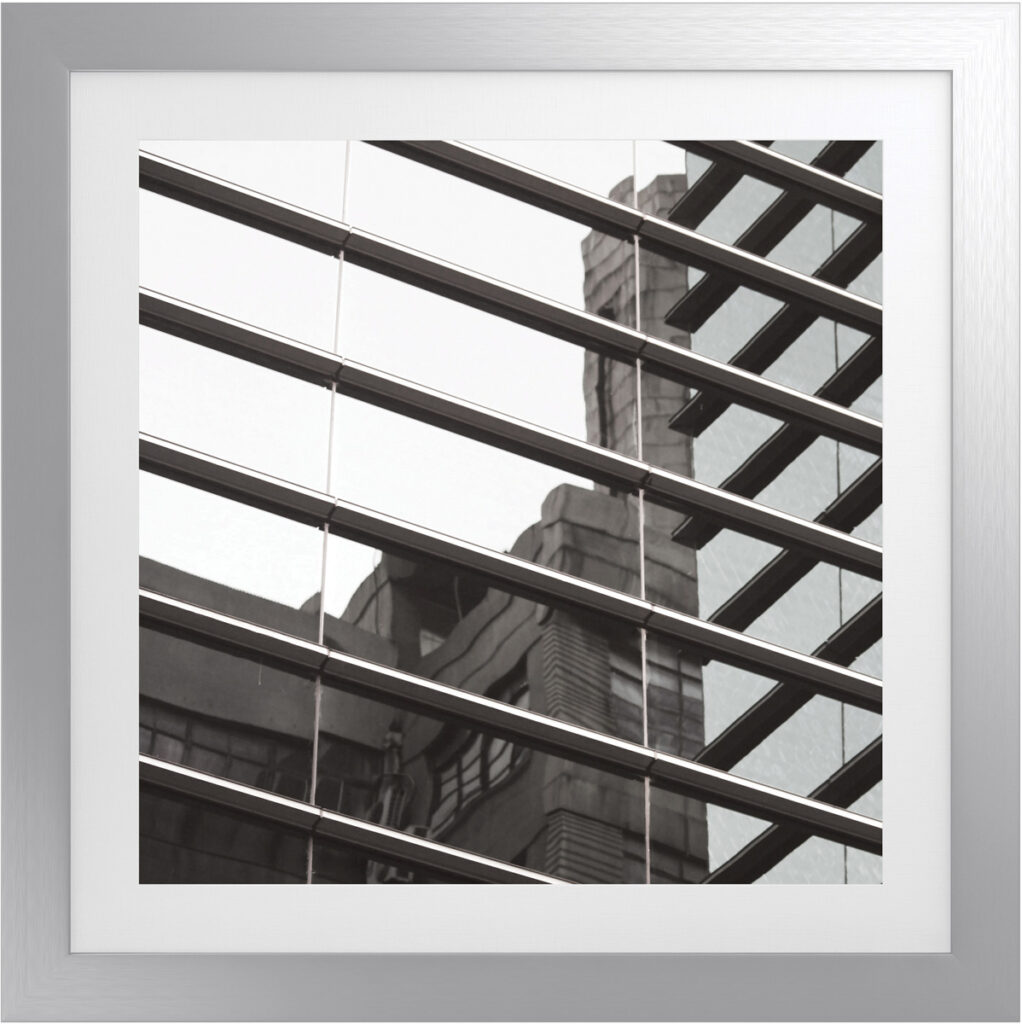Abstract geometric square artwork with reflective glass and metal frame.